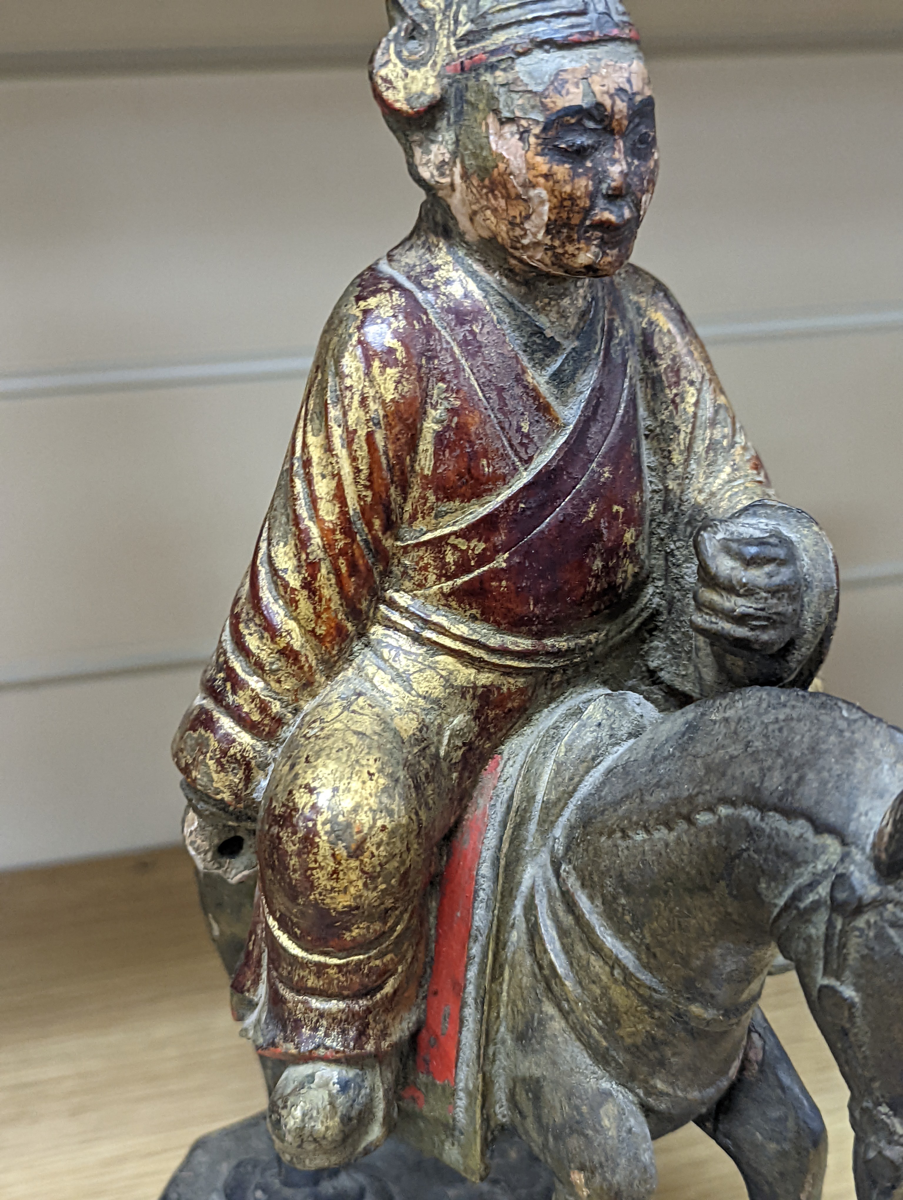 An 18th/19th century Chinese lacquered wood group of an official riding a horse, 30cm